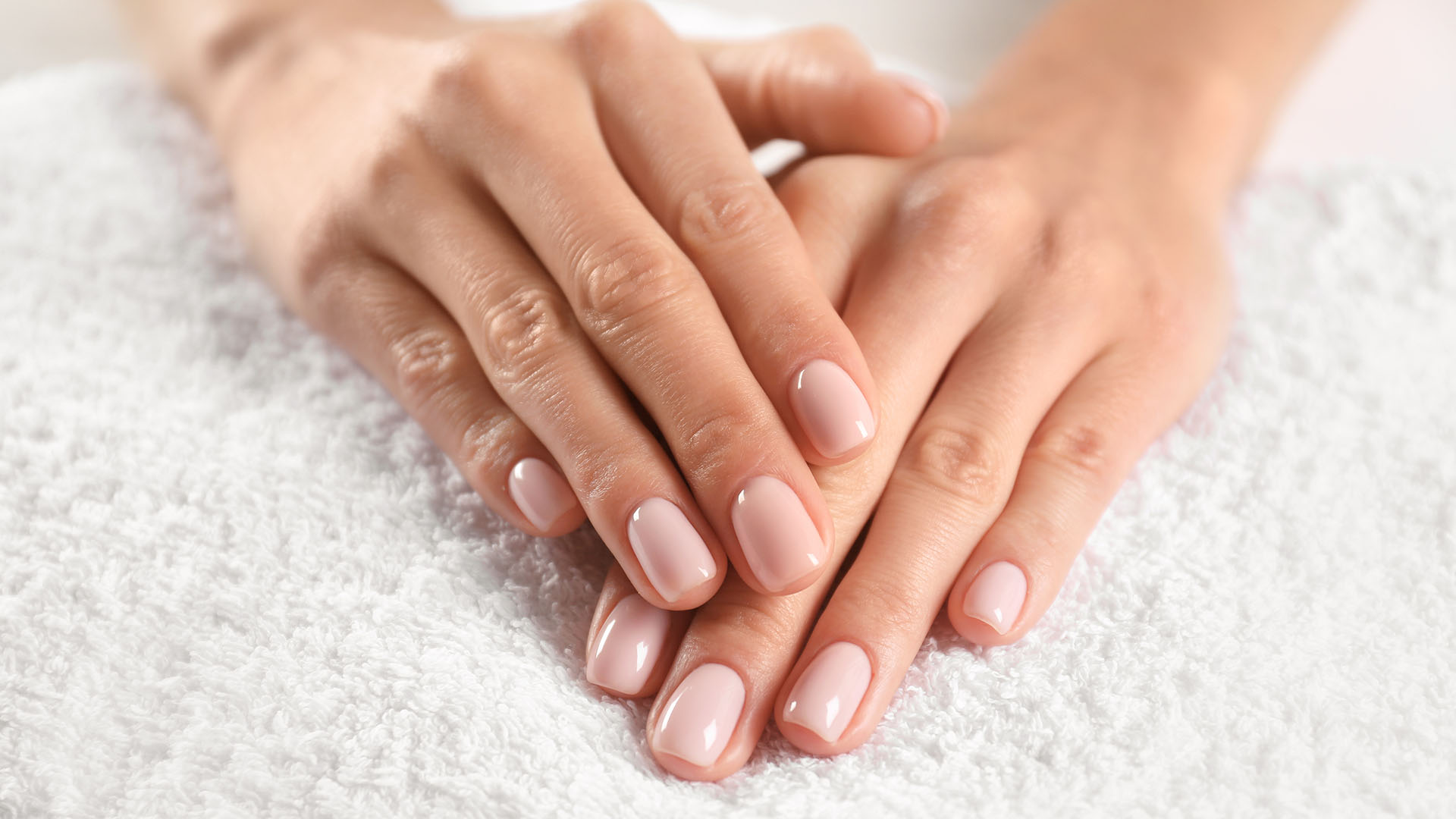 Closeup view of beautiful female hands on towel. Spa treatment